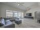 Spacious living room with seamless outdoor access, stylish decor, fan, and entertainment center at 797 E Cedar Dr, Chandler, AZ 85249