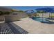 Well-maintained pool with nearby built-in grill is set in a large tiled patio with patio seating at 797 E Cedar Dr, Chandler, AZ 85249