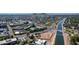 Aerial shot of the city with a canal running through the landscape and mountains in the distance at 8301 E Indianola Ave, Scottsdale, AZ 85251