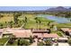 Aerial view showcases golf course with lush fairways, mature trees and a lake near the clubhouse at 8301 E Indianola Ave, Scottsdale, AZ 85251
