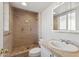 Bright bathroom features a tiled shower, modern sink, and ample counter space, providing both style and functionality at 8301 E Indianola Ave, Scottsdale, AZ 85251