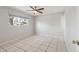 Clean, spacious room with tile floor, window with neighborhood view and a ceiling fan with light at 8301 E Indianola Ave, Scottsdale, AZ 85251
