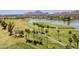 Scenic view of lush golf course, lake, palm trees and mountain backdrop, ideal for outdoor enthusiasts at 8301 E Indianola Ave, Scottsdale, AZ 85251