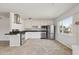 Well-lit kitchen featuring granite countertops, stainless steel appliances, white cabinets, and a stylish range hood at 8301 E Indianola Ave, Scottsdale, AZ 85251