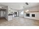 Modern kitchen featuring stainless steel appliances, granite countertops, white cabinetry and a view to the living room at 8301 E Indianola Ave, Scottsdale, AZ 85251