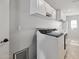 Functional laundry room with white cabinets, a washing machine, dryer, and ample counter space at 8301 E Indianola Ave, Scottsdale, AZ 85251