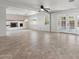 Bright living room featuring tile flooring, a fireplace, and glass doors leading to the outdoor pool area at 8301 E Indianola Ave, Scottsdale, AZ 85251