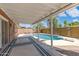 Inviting pool area with a covered patio, palm trees, and clear blue water, perfect for outdoor relaxation and entertainment at 8301 E Indianola Ave, Scottsdale, AZ 85251
