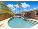 Outdoor view showcasing a sparkling pool, covered patio, and lush landscaping, creating a perfect backyard oasis at 8301 E Indianola Ave, Scottsdale, AZ 85251