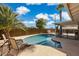 Enjoy this sparkling pool with palm trees for a relaxing backyard oasis on a sunny day at 8301 E Indianola Ave, Scottsdale, AZ 85251