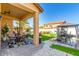 Inviting covered patio with outdoor seating, manicured turf, and a gazebo in a private backyard oasis at 84 E Joseph Way, Gilbert, AZ 85295