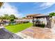 Lush backyard with a gazebo, artificial turf, and a fenced pool area for outdoor enjoyment at 84 E Joseph Way, Gilbert, AZ 85295