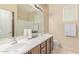Bright bathroom with double sink vanity, large mirror, and a separate toilet room for added privacy at 84 E Joseph Way, Gilbert, AZ 85295