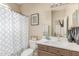 Charming bathroom featuring a shower-tub combo with a patterned shower curtain and sleek vanity with decor at 84 E Joseph Way, Gilbert, AZ 85295