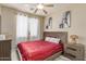 Bright bedroom with a window, ceiling fan, and charming decor. Comfortable and stylish for relaxation and rest at 84 E Joseph Way, Gilbert, AZ 85295