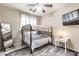 Cozy bedroom featuring a bunk bed with ceiling fan and a full length mirror, perfect for a room at 84 E Joseph Way, Gilbert, AZ 85295