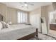 Cozy bedroom with neutral decor, a ceiling fan, and large windows providing ample natural light at 84 E Joseph Way, Gilbert, AZ 85295