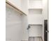 Spacious closet with multiple levels of shelving and wooden rods for optimal clothing and accessories organization at 84 E Joseph Way, Gilbert, AZ 85295
