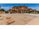 Elegant two-story home with a spacious driveway, two-car garage, and low-maintenance desert landscaping at 84 E Joseph Way, Gilbert, AZ 85295