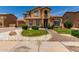 Charming two-story home featuring a manicured lawn, desert landscaping and tiled roof at 84 E Joseph Way, Gilbert, AZ 85295