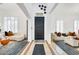 Bright foyer features a black door, shuttered windows, and stylish neutral furniture on top of light-colored tile at 84 E Joseph Way, Gilbert, AZ 85295