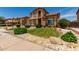 Well-maintained front yard with lush green lawn, desert landscaping, and a two-story home at 84 E Joseph Way, Gilbert, AZ 85295