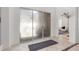 Hallway with frosted glass sliding doors with view of a sunlit living room with stylish furniture at 84 E Joseph Way, Gilbert, AZ 85295