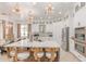 Modern kitchen with a large island, stainless steel appliances, and stylish lighting fixtures at 84 E Joseph Way, Gilbert, AZ 85295