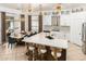 Open kitchen featuring a large center island with seating, designer lighting, and modern appliances at 84 E Joseph Way, Gilbert, AZ 85295