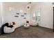Living room with neutral colors, plantation shutters, modern lighting, and minimalist shelving at 84 E Joseph Way, Gilbert, AZ 85295