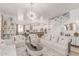 Bright living room with white sofas, chairs, a decorative rug, and a statement chandelier at 84 E Joseph Way, Gilbert, AZ 85295