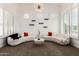 Cozy living room featuring stylish furniture, minimalist shelving, plantation shutters, and unique lighting at 84 E Joseph Way, Gilbert, AZ 85295