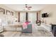Cozy main bedroom featuring a plush bed, seating area, ceiling fan, and large windows at 84 E Joseph Way, Gilbert, AZ 85295
