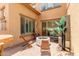 Outdoor patio area with a fire pit, seating, and views into the home at 84 E Joseph Way, Gilbert, AZ 85295