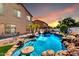 Backyard pool with rock waterfall, mature palms, baja shelf, and outdoor seating for relaxed entertaining at 84 E Joseph Way, Gilbert, AZ 85295