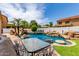 Inviting pool area with rock features, slide, lush greenery, and outdoor dining space, perfect for entertaining at 84 E Joseph Way, Gilbert, AZ 85295