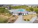 Aerial shot of the community pool and clubhouse with palm trees, lounge chairs, and well-maintained landscaping at 8836 W Orange Dr, Glendale, AZ 85305