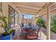 A cozy covered patio with a wrought iron dining set, perfect for outdoor entertaining at 912 W Sunward Dr, Gilbert, AZ 85233