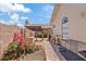 Backyard with a brick paver walkway, dog kennel, and blossoming bougainvillea at 912 W Sunward Dr, Gilbert, AZ 85233