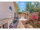 View of the backyard with a brick paver walkway, dog run and mature flowering plants at 912 W Sunward Dr, Gilbert, AZ 85233