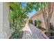 Sideyard featuring brick pavers, mature landscaping, a covered patio, and access to outdoor space at 912 W Sunward Dr, Gilbert, AZ 85233