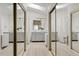 Bathroom boasting dual vanities, framed mirrors, and a walk-in shower with a glass door, offering a spa-like experience at 912 W Sunward Dr, Gilbert, AZ 85233
