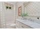 Bathroom showcasing floral-patterned wallpaper, modern fixtures, and a stylish vanity with sink at 912 W Sunward Dr, Gilbert, AZ 85233