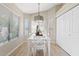 Bright dining area with a modern light fixture, large windows, and a white dining set at 912 W Sunward Dr, Gilbert, AZ 85233