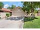 Charming single-story home with a two-car garage, a low maintenance yard and a well-kept lawn at 912 W Sunward Dr, Gilbert, AZ 85233