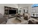 Comfortable living room showcasing vaulted ceilings, a large entertainment center, sofas, and elegant arched windows for natural light at 912 W Sunward Dr, Gilbert, AZ 85233