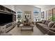 Inviting living room featuring a large entertainment center, two sofas and elegant decor under a vaulted ceiling at 912 W Sunward Dr, Gilbert, AZ 85233