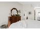 Cozy main bedroom features plush white bedding, wood-look flooring, and stylish furnishings, offering a tranquil atmosphere at 912 W Sunward Dr, Gilbert, AZ 85233