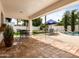 Spacious covered patio with terra cotta tile, seating area, and view of the landscaped backyard and pool at 9637 E Gold Dust Ave, Scottsdale, AZ 85258
