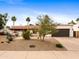 Beautiful single-story home featuring a landscaped front yard with desert accents at 9637 E Gold Dust Ave, Scottsdale, AZ 85258
